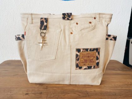 Handmade recycled brown denim shoulder bag shown flat